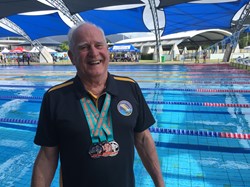 John Collis displays his medals at Tobruk Pool, Cairns, 2021